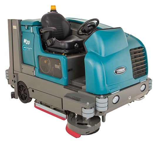 Blue ride-on floor scrubber with operator seat, steering wheel, and a red scrubbing brush underneath for industrial cleaning.